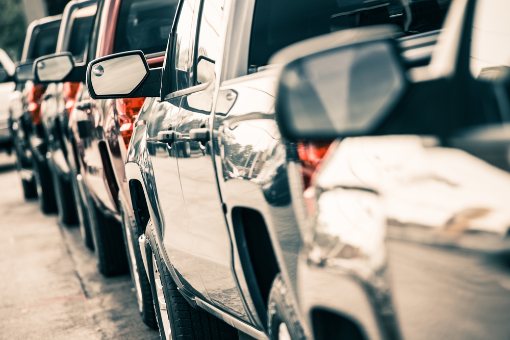 Line of vehicles in traffic, sides of trucks, side-view mirrors