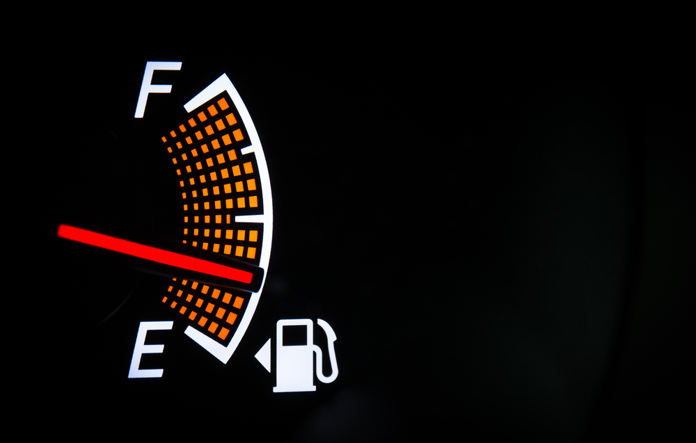 Fuel gauge 1/4 full with gas pump symbol and arrow indicating gas tank on left