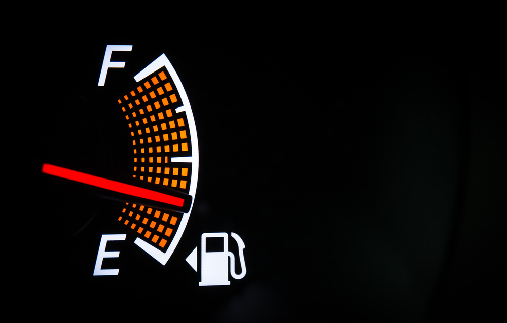 Fuel gauge 1/4 full with gas pump symbol and arrow indicating gas tank on left Fuel gauge 1/4 full with gas pump symbol and arrow indicating gas tank on left